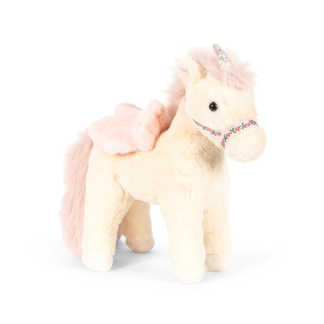 A plush unicorn toy with cream-colored fur, a fluffy pink mane and tail, a small pink wing, and a floral-patterned bridle, shown on a white background.