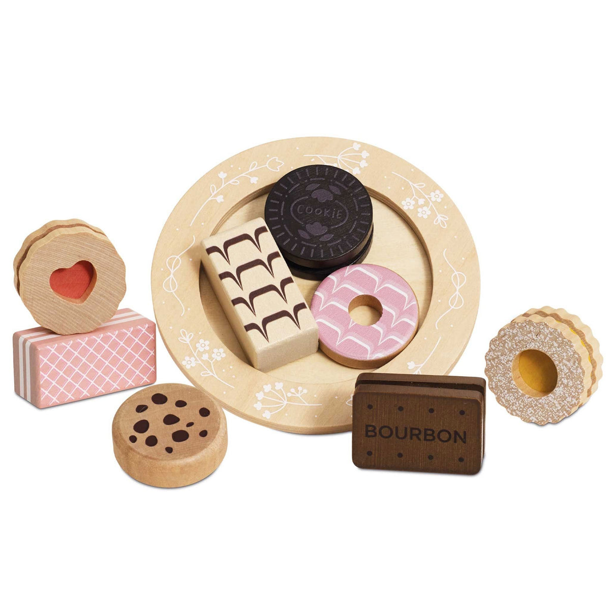 A set of wooden toy biscuits arranged on a round beige plate with floral detailing, including a pink iced ring, a dark chocolate cookie, a patterned rectangular piece, a heart-shaped cookie, and a brown rectangular piece labeled BOURBON, photographed on a white background.
