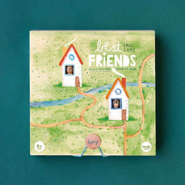 The board game box for 'Best Friends' Logic Game is shown against a solid teal background. The box features a whimsical illustration of two small houses on a green grassy landscape with winding orange paths and a blue river. The box has two cut-out windows where a wooden otter and rabbit are visible through the holes.