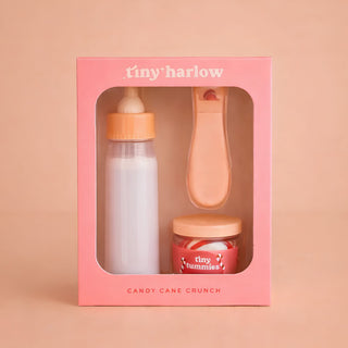 Baby product set in a pink box with 'tiny harlow' branding on a beige background