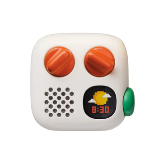 A white Yoto 4th Gen Mini Player with orange knobs, a green button, and a small card, shown floating against a white background.